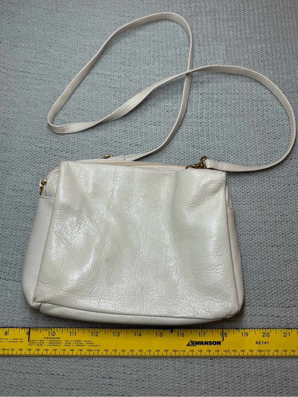 Minimalist Tignanello Cream Leather Crossbody Bag with Gold Hardware